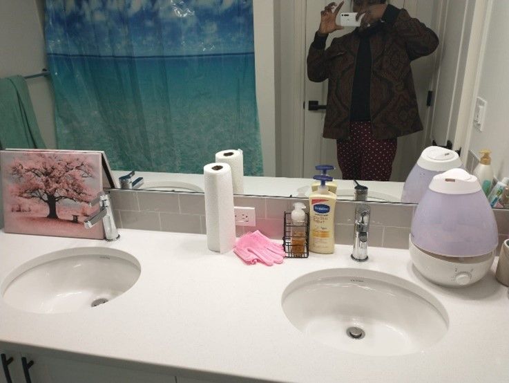 A man is taking a picture of himself in the bathroom mirror