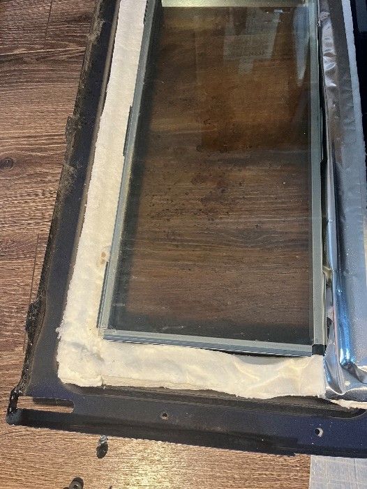 A piece of glass is sitting on top of a wooden table.