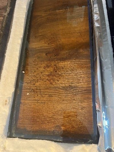 A piece of wood is sitting on top of a white surface.