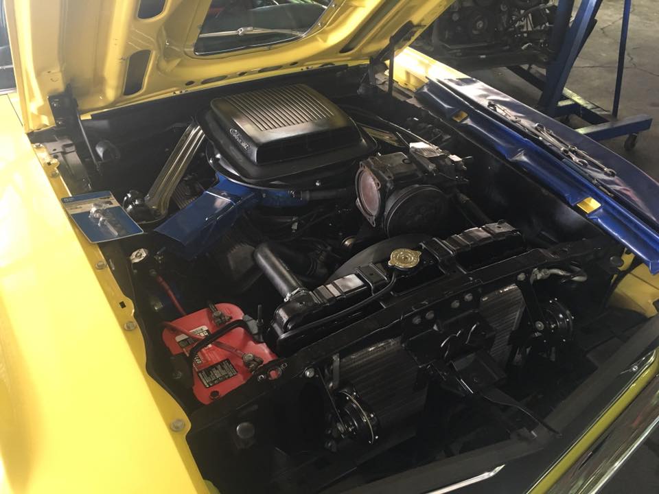 under the hood of a yellow car