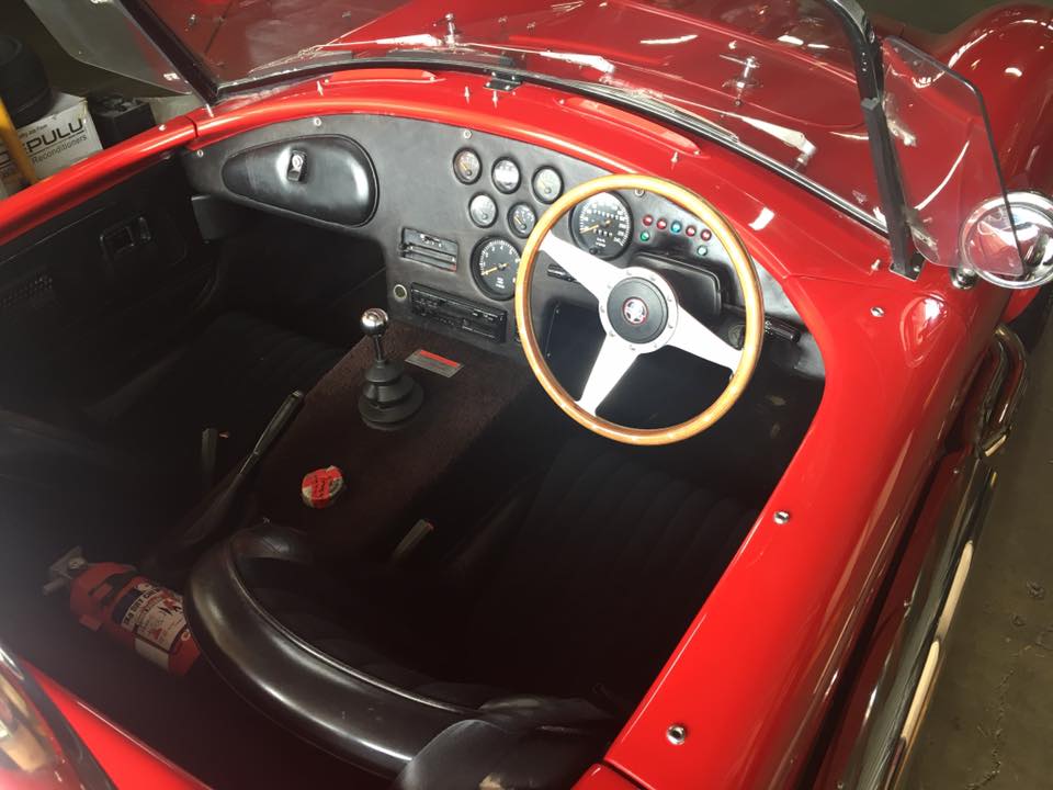 a white steering wheel inside of a red car