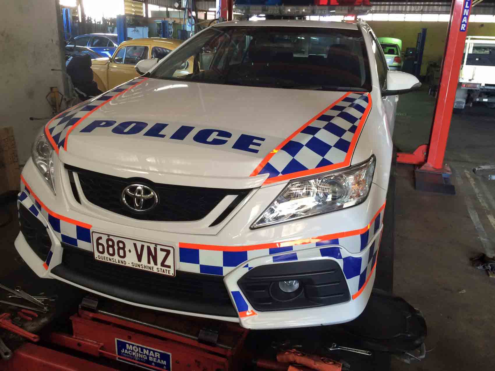 a police car that is white, blue and orange