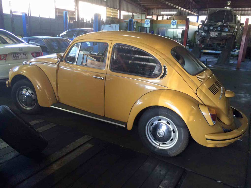 an old yellow bug car