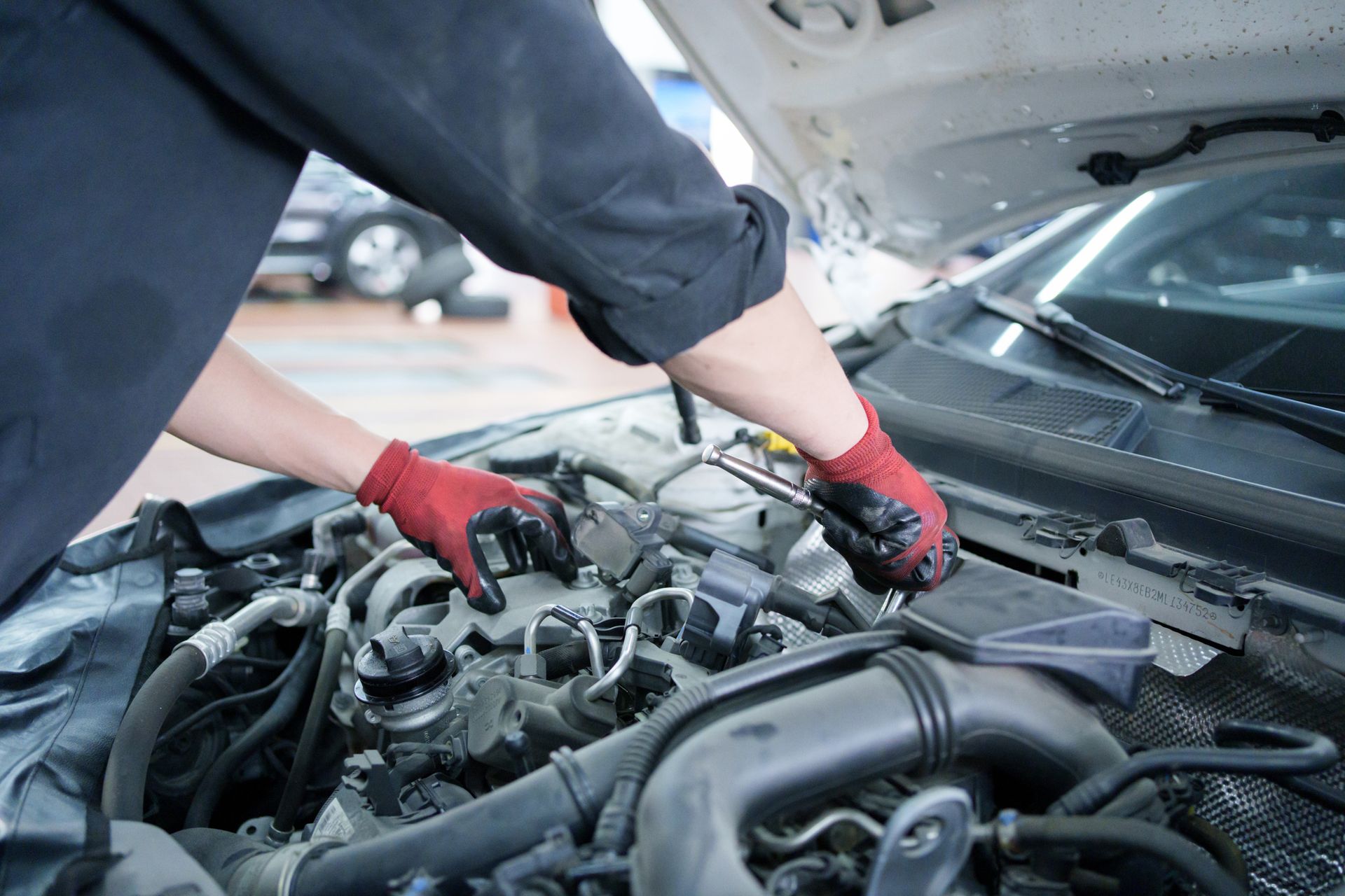 A Silver SUV Is Parked in Front of A Brick Building | El Paso, TX | Jerry’s Auto Repair & Tire
