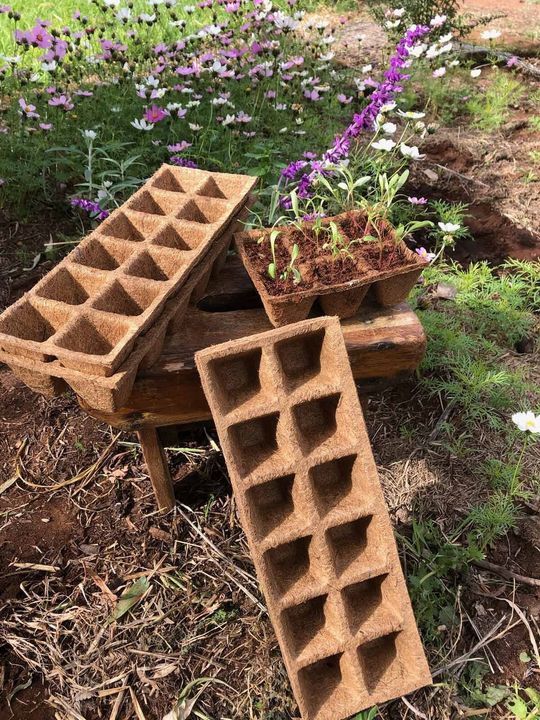 A stack of wooden blocks sitting on top of each other in a garden.