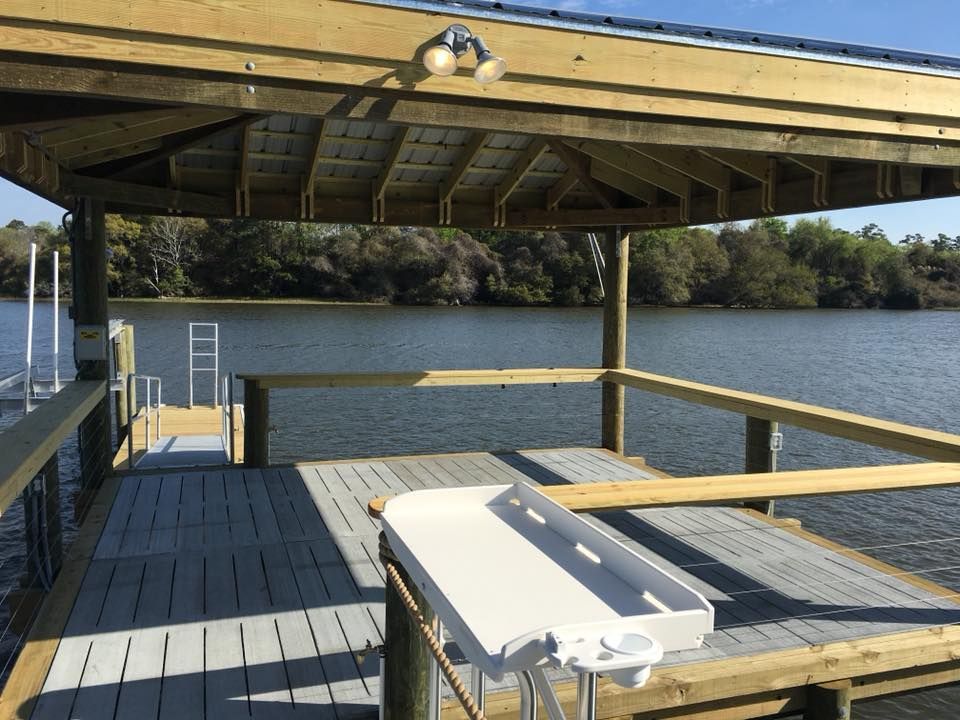 A dock with a gazebo overlooking a body of water