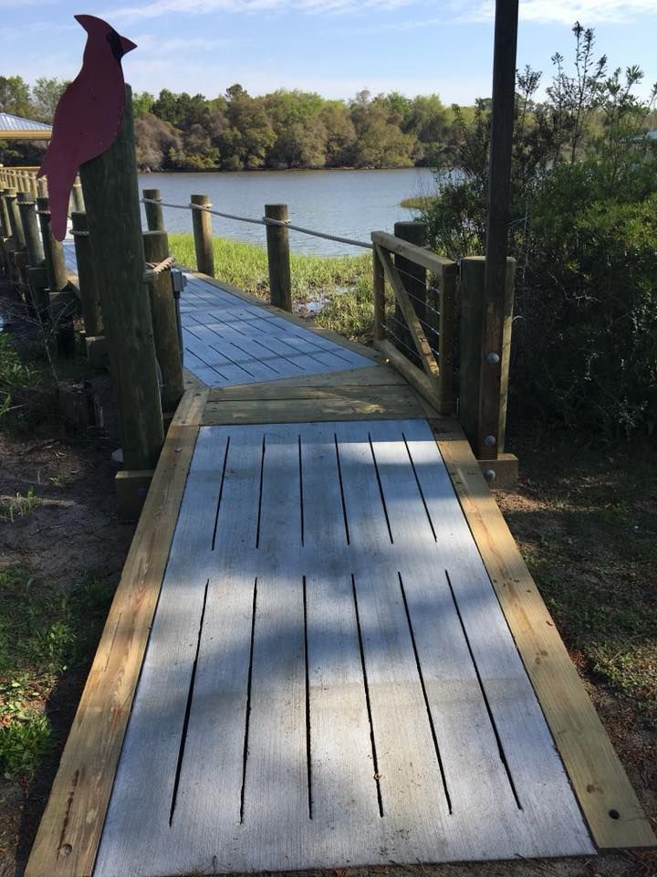 A wooden walkway leading to a body of water