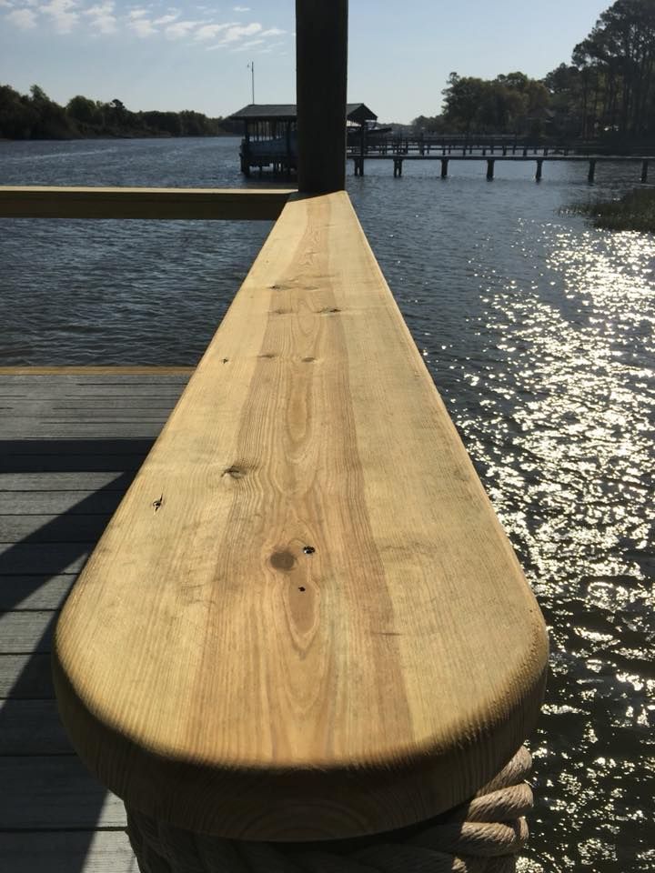 A wooden railing overlooking a body of water
