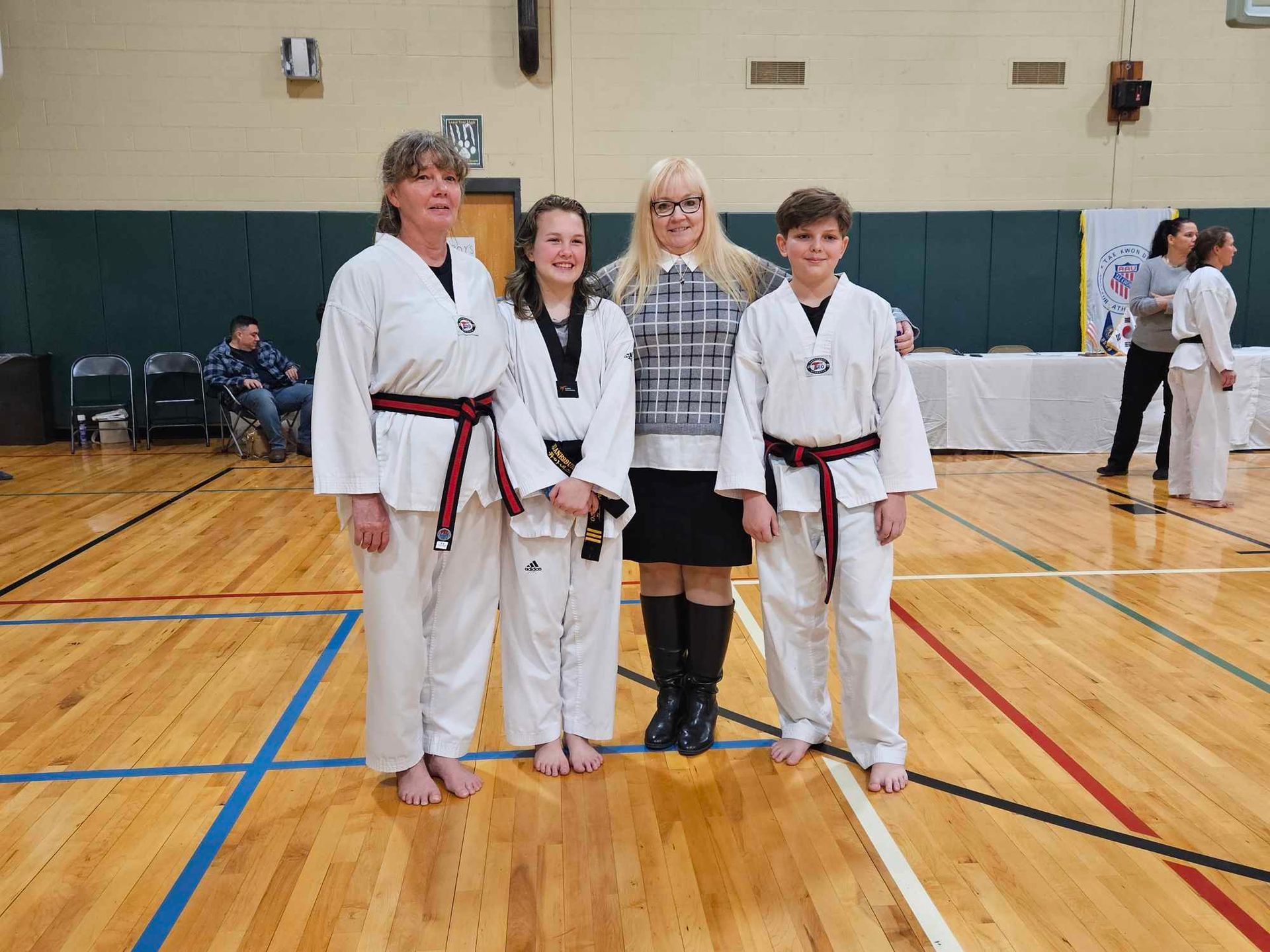 A group of people are posing for a picture in a gym.