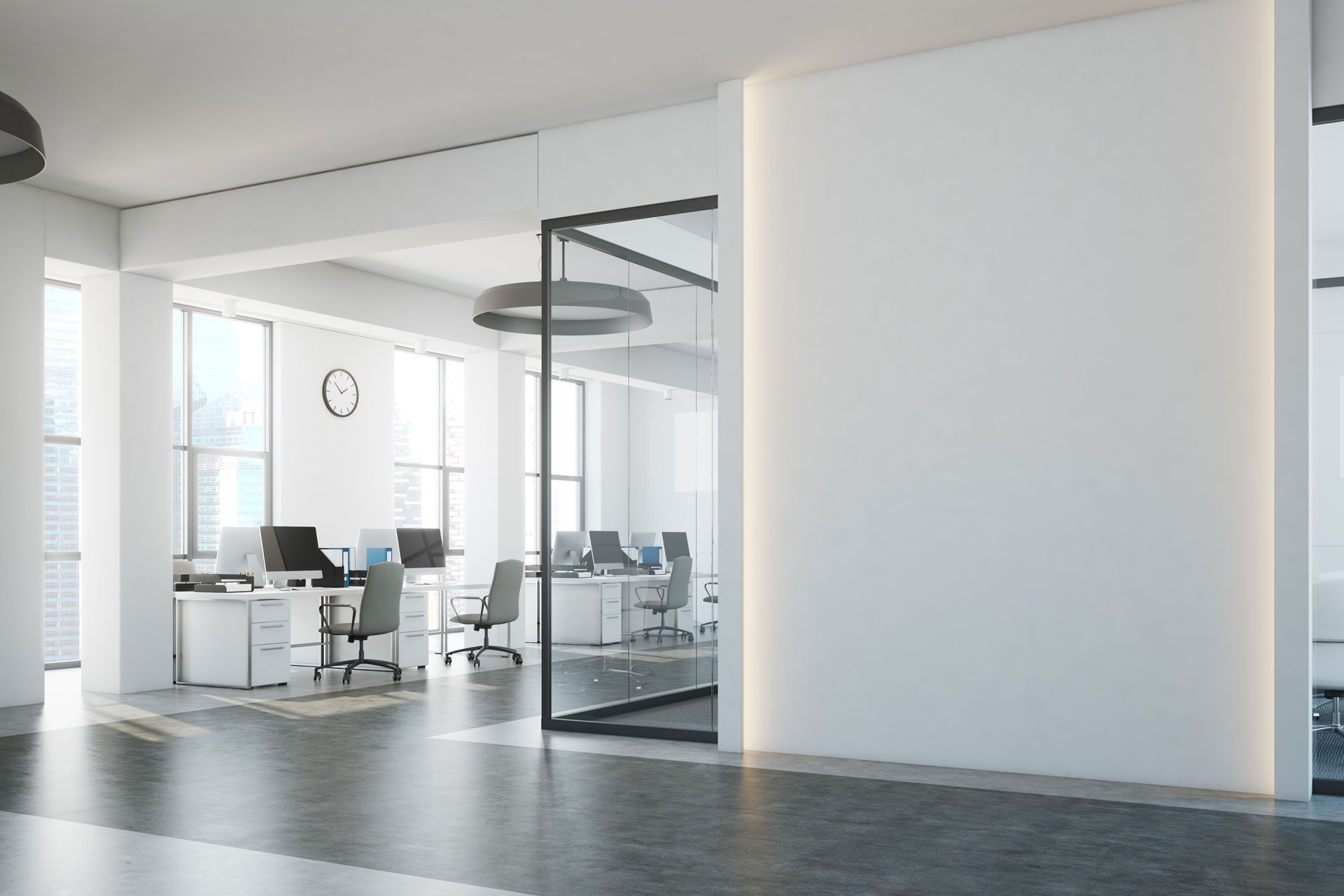 Modern office interior with workstations, glass walls, and white walls.