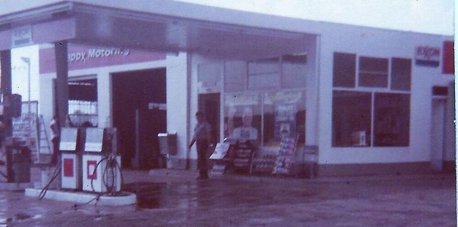 A black and white photo of a gas station