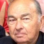 A close up of a man 's face with a serious look on his face.