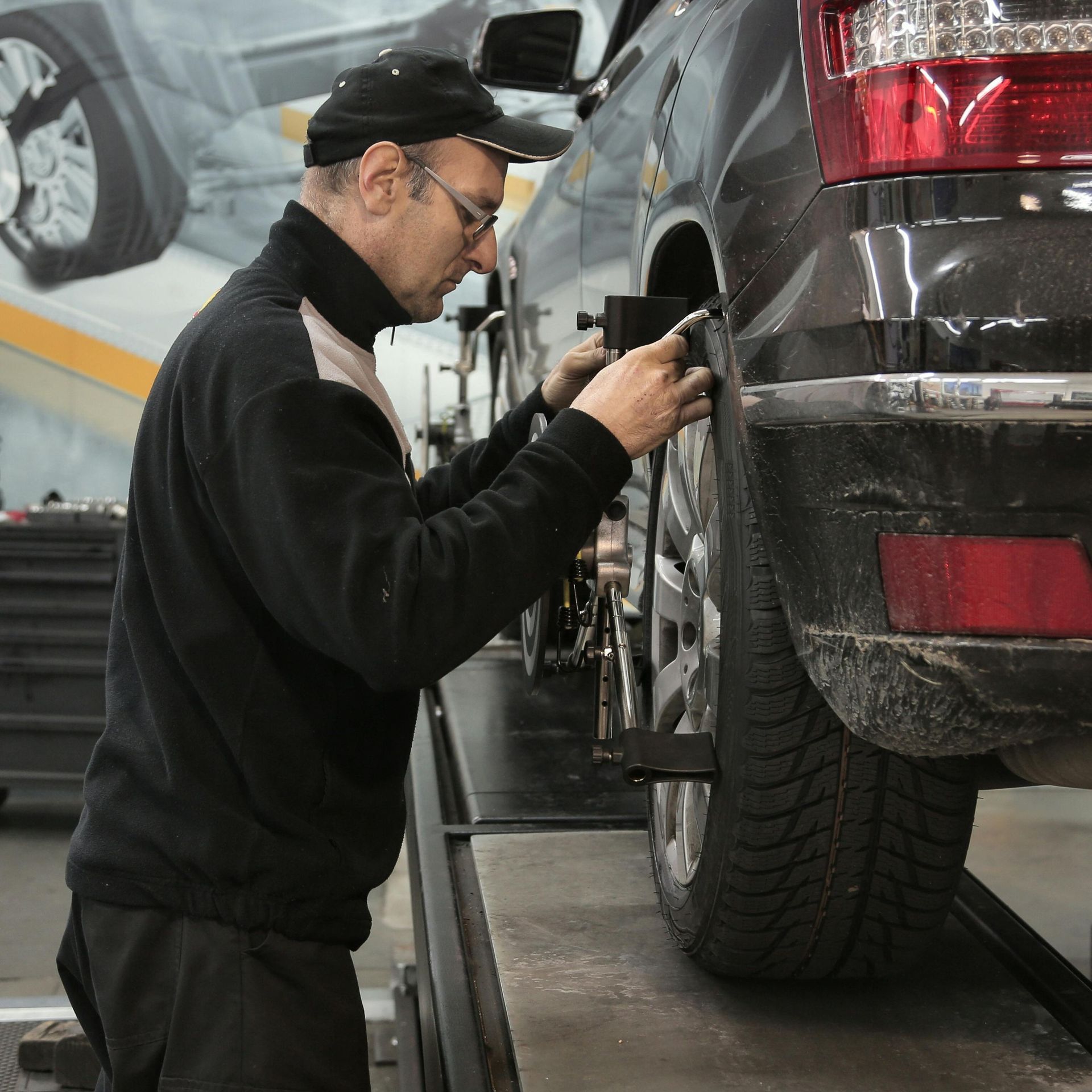 A man is working on a car in a garage