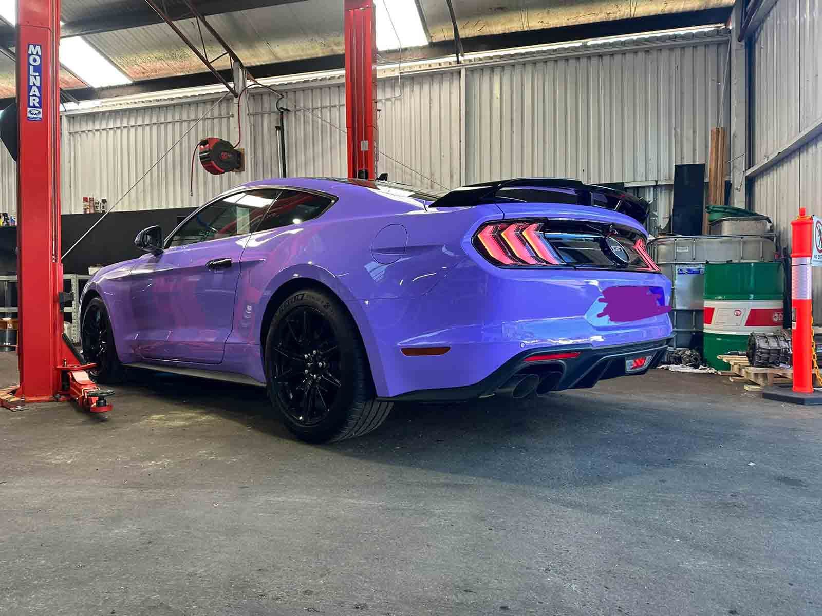 A Purple Mustang Is Parked On A Red Lift In A Garage — AZNU Automotive In Lismore, NSW