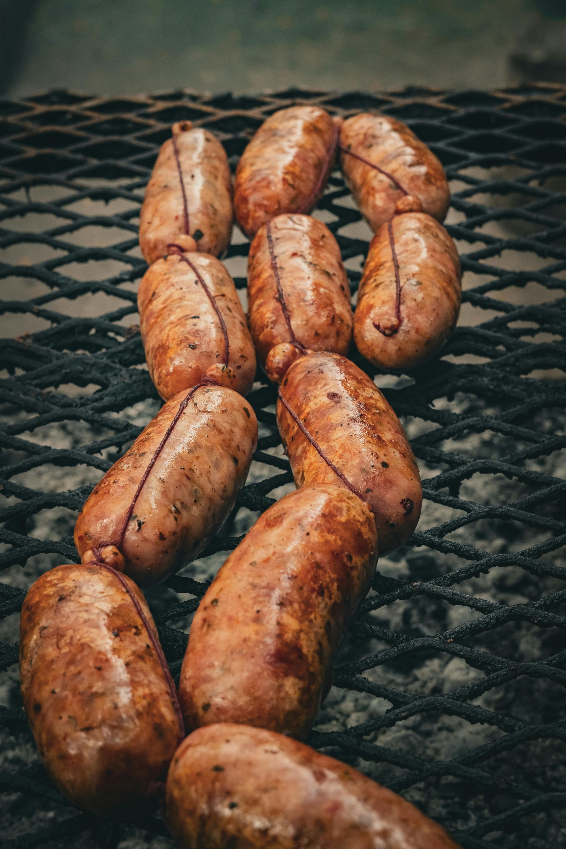 Grilled choriso-ausages browning on a barbecue grate