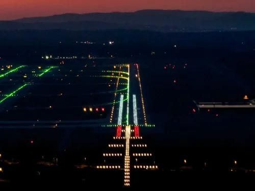Night runway with bright center lights and green edge lights