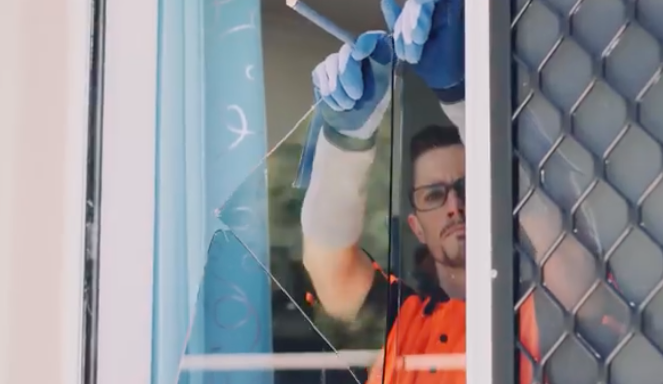 Workman Removing Broken Glass - Emergency Glass Repairs in Gold Coast, QLD