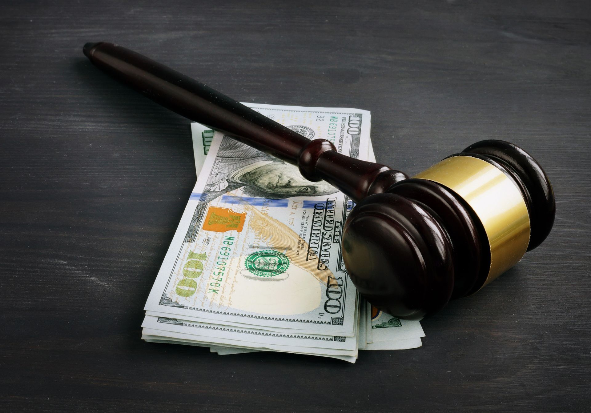 A gavel on top of a stack of money.