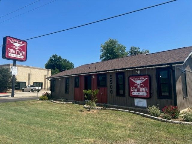 A brown building with a sign that says cow town