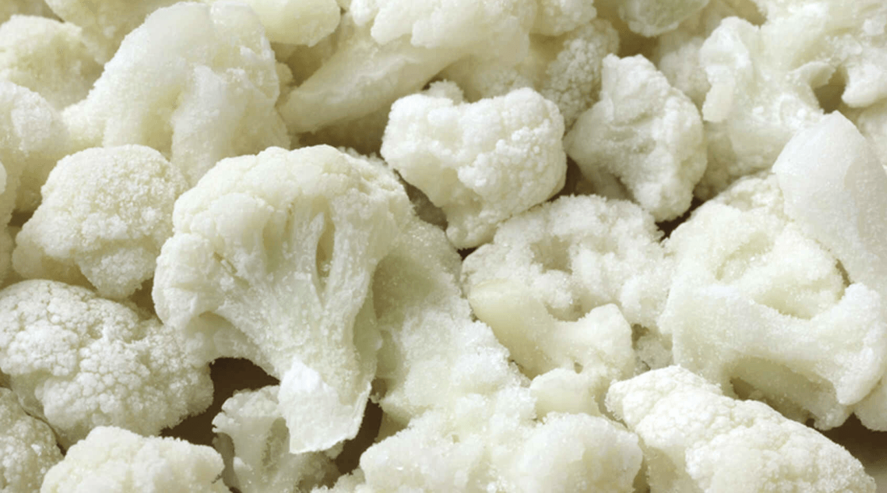Una pila de coliflor congelada está sobre una mesa.