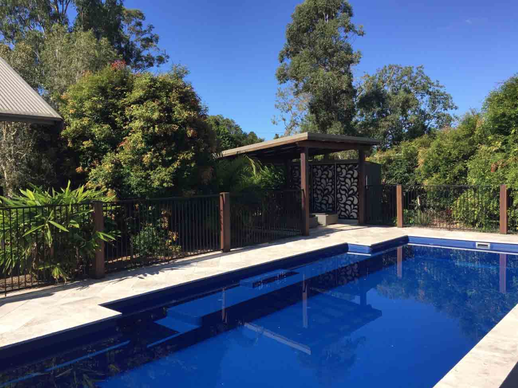 Swimming Pool With Small Fountain From A Corner — Fibreglass Pools In Grafton, NSW