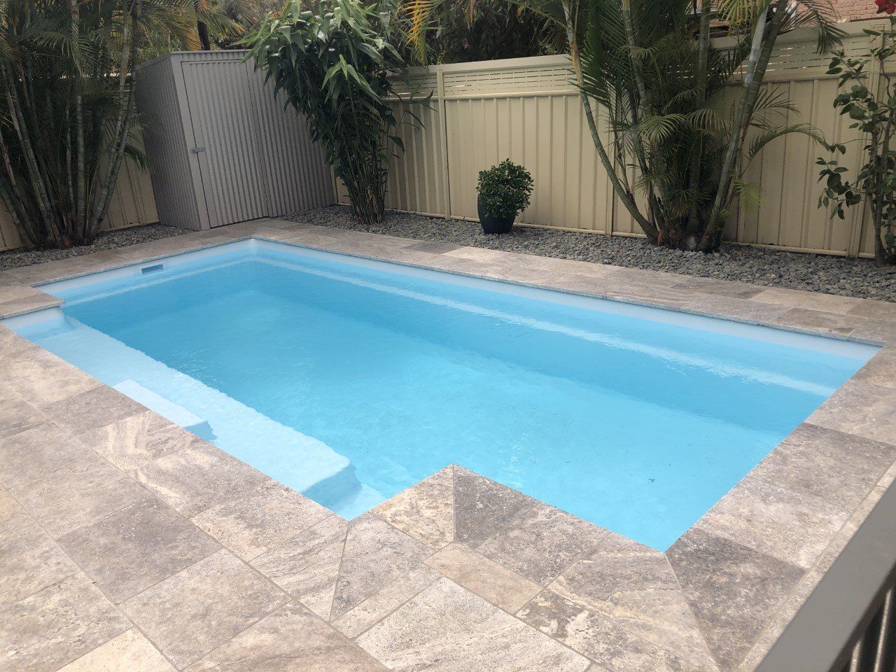 Swimming Pool With Wooden Flooring — Fibreglass Pools In Grafton, NSW