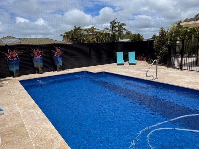 Man Cleaning The Pool With A Net — Fibreglass Pools In Grafton, NSW