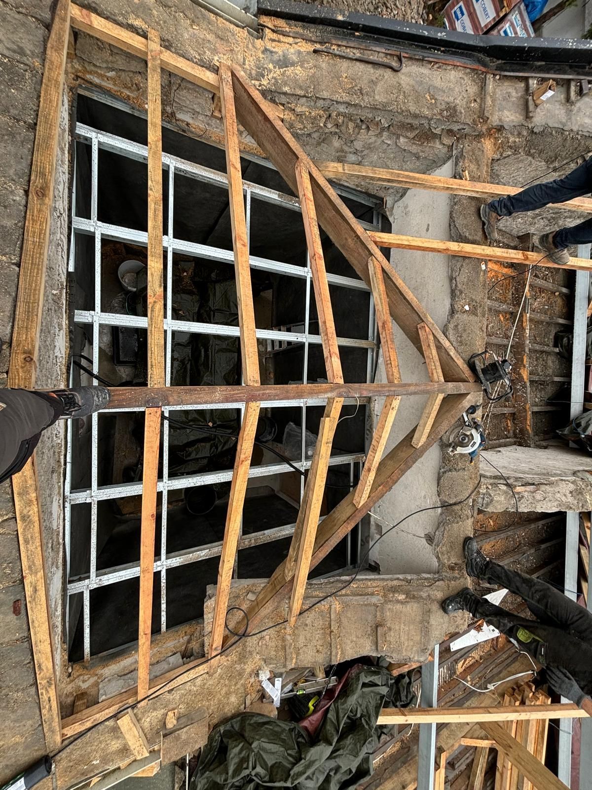 Uma moldura de madeira está sendo construída ao redor de uma janela em um prédio.