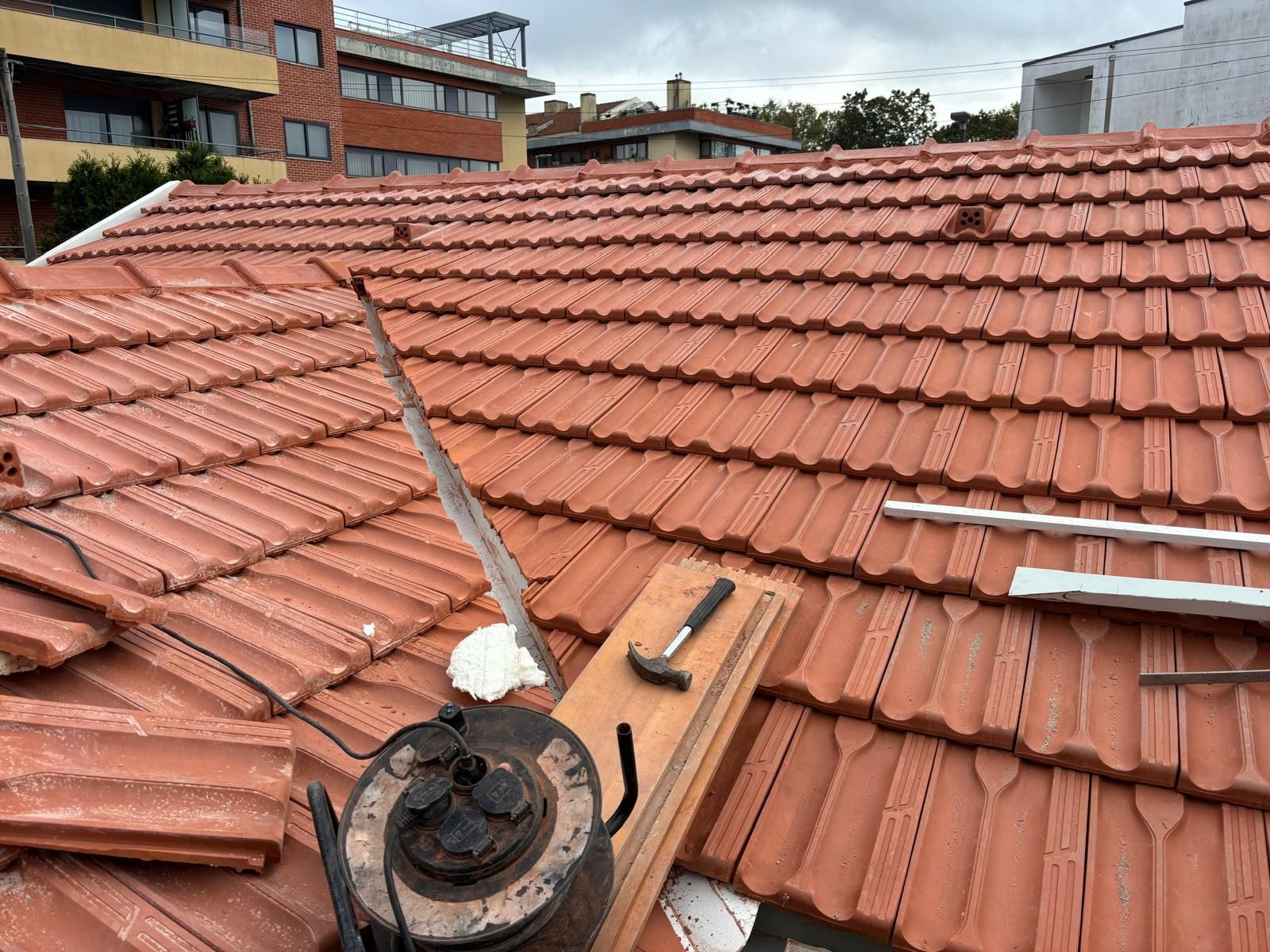 Um telhado com uma chaleira e um martelo em cima.