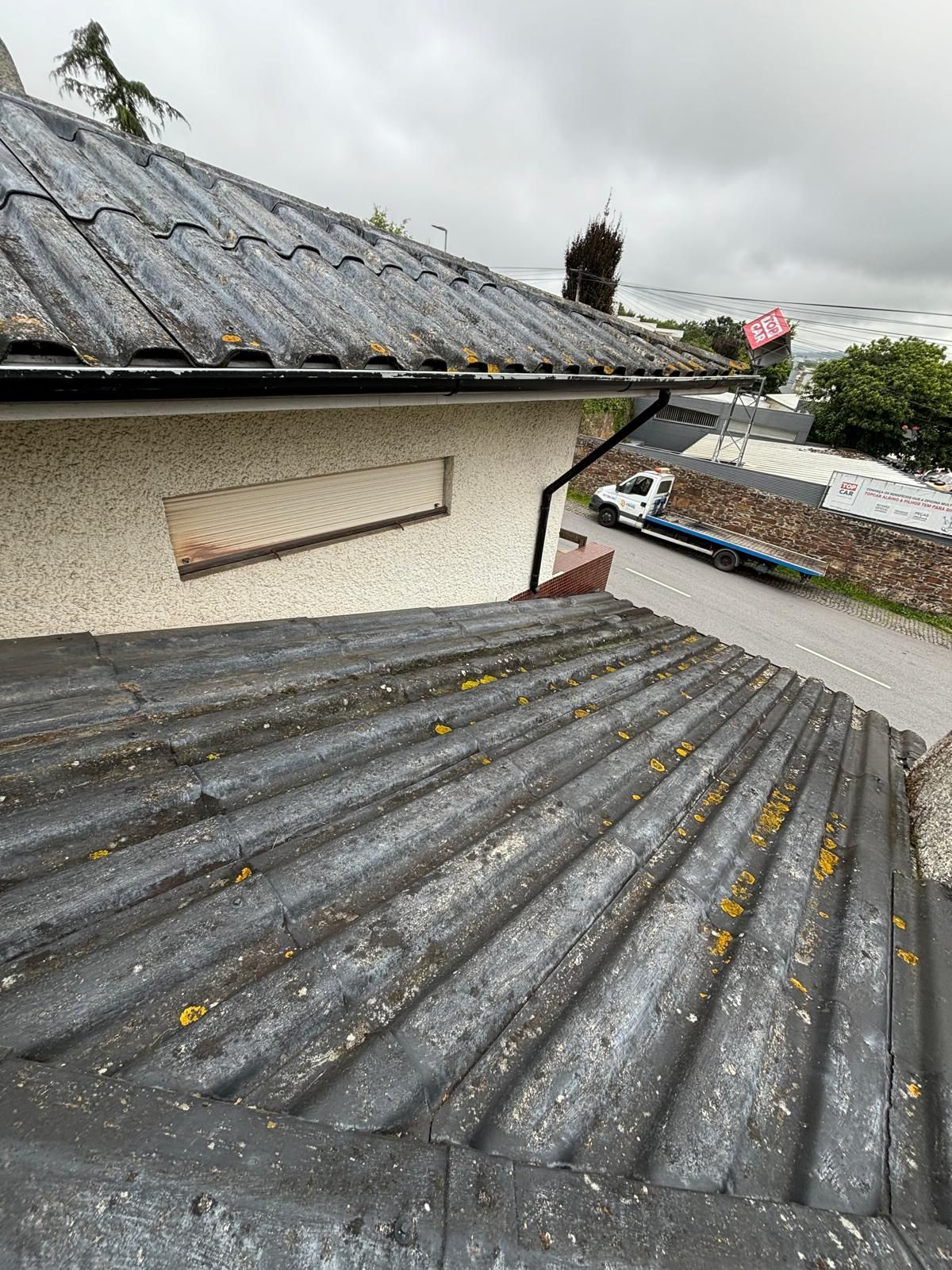 Um telhado de uma casa com uma calha e uma chaminé.