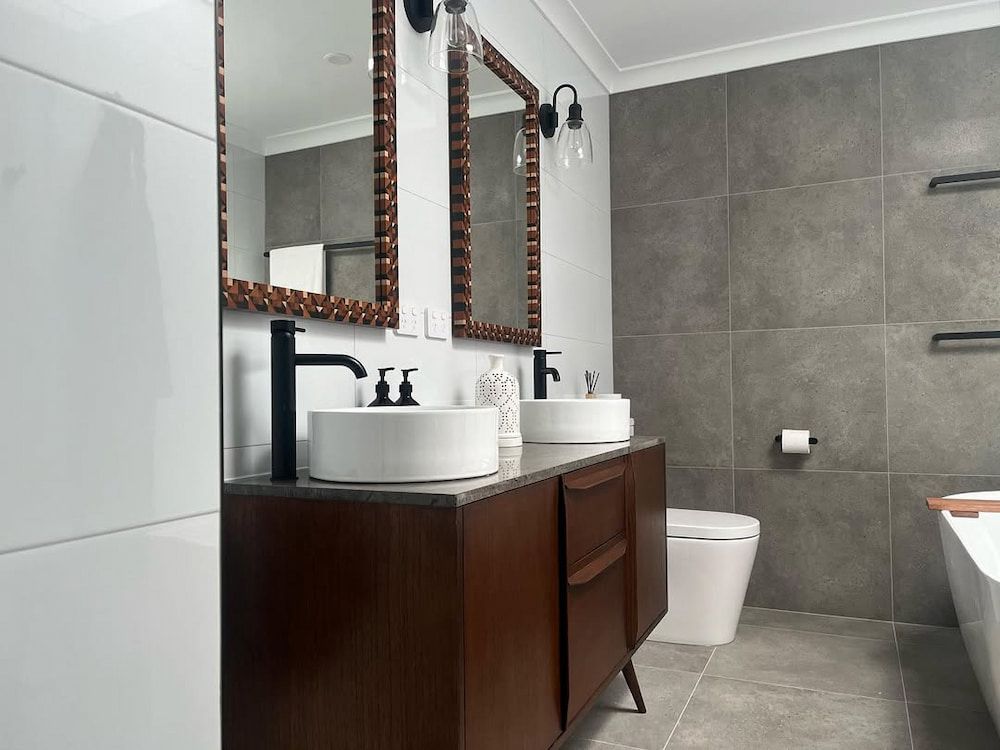 A Bathroom With Two Sinks a Toilet and a Mirror — Canberra Bathroom Solutions in Ngunnawal, ACT