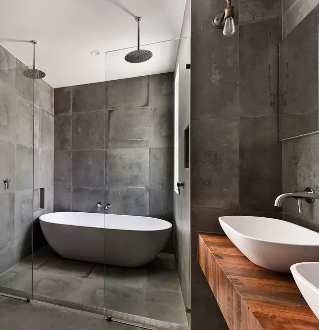 A Modern Bathroom With Grey Tiled Walls and Floors— Canberra Bathroom Solutions in Gungahlin, ACT