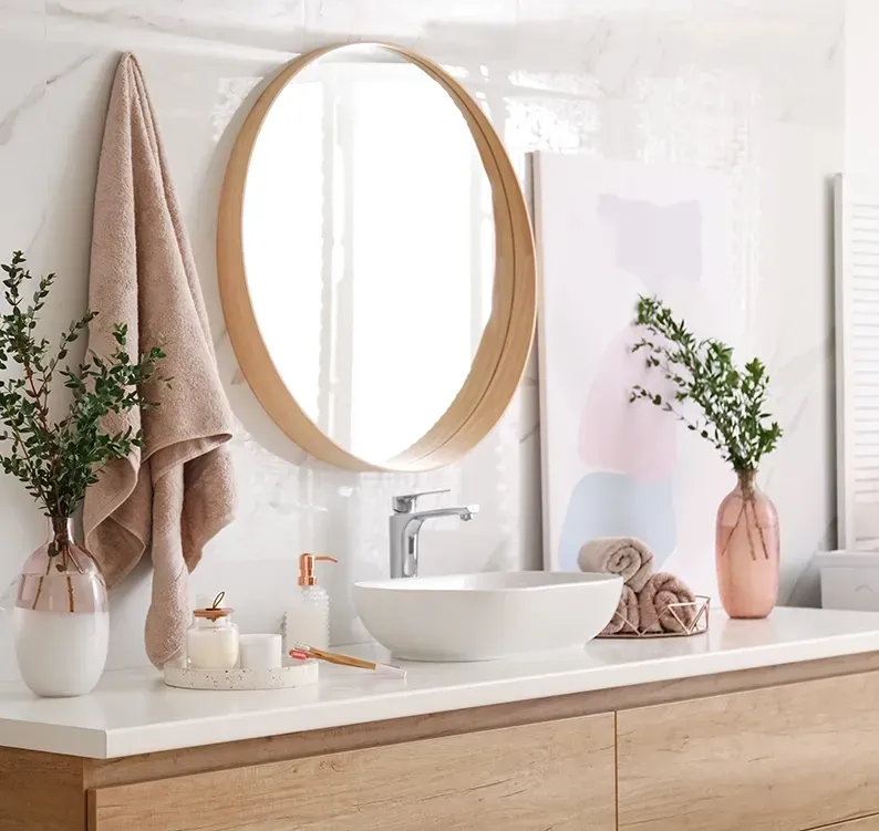 A Bathroom With Wooden Vanity And Large Round Mirror — Canberra Bathroom Solutions in Gungahlin, ACT