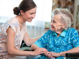 caregiver and patient chatting and smiling