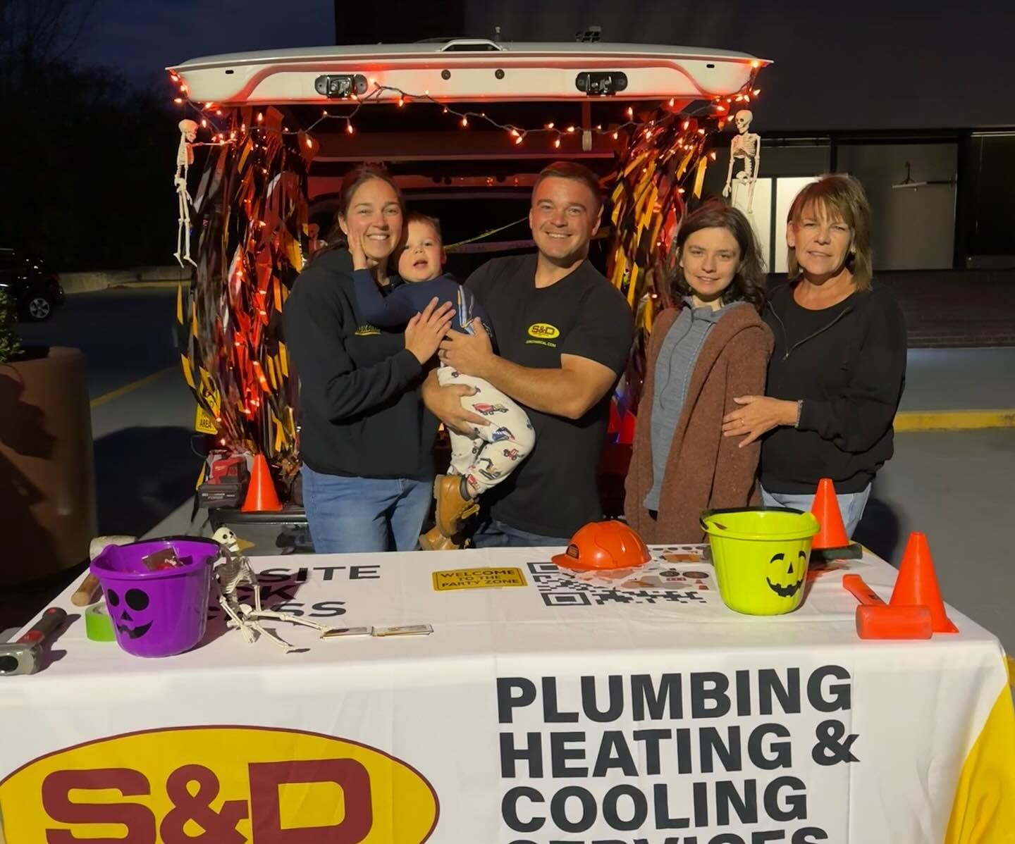 Family at a trunk-or-treat event with