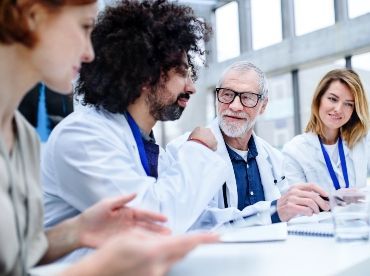 a picture of a group of hair transplant surgeons in London engaging in a discussion