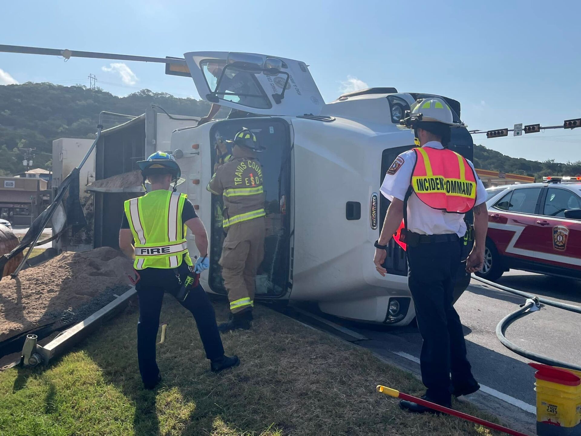 A truck has turned over on the side of the road.