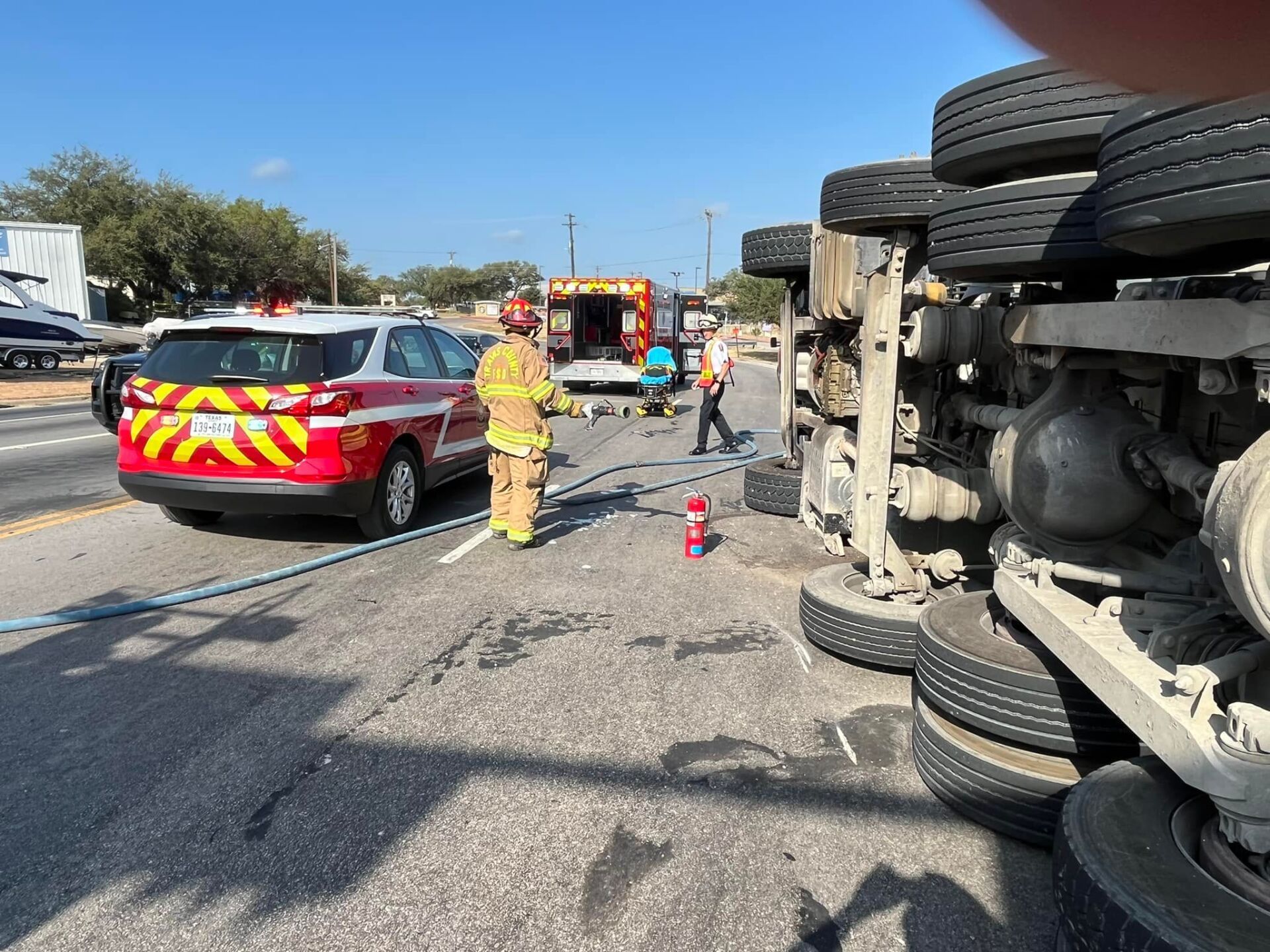 A truck has turned over on the side of the road.