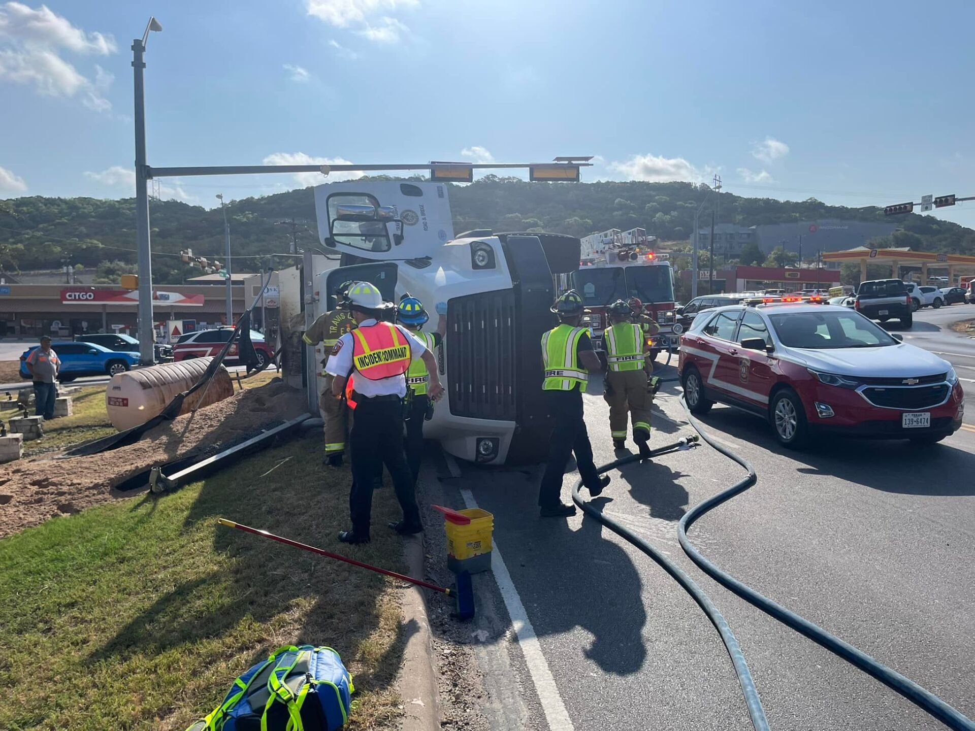 A truck has turned over on the side of the road.