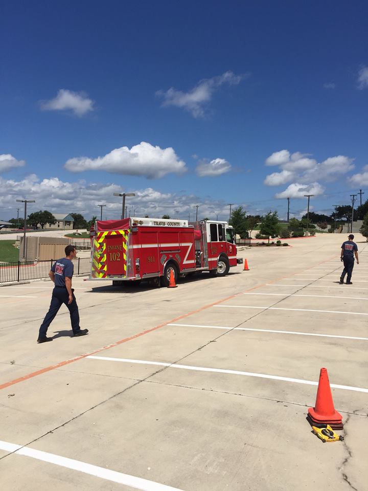 A red fire truck is parked in a parking lot