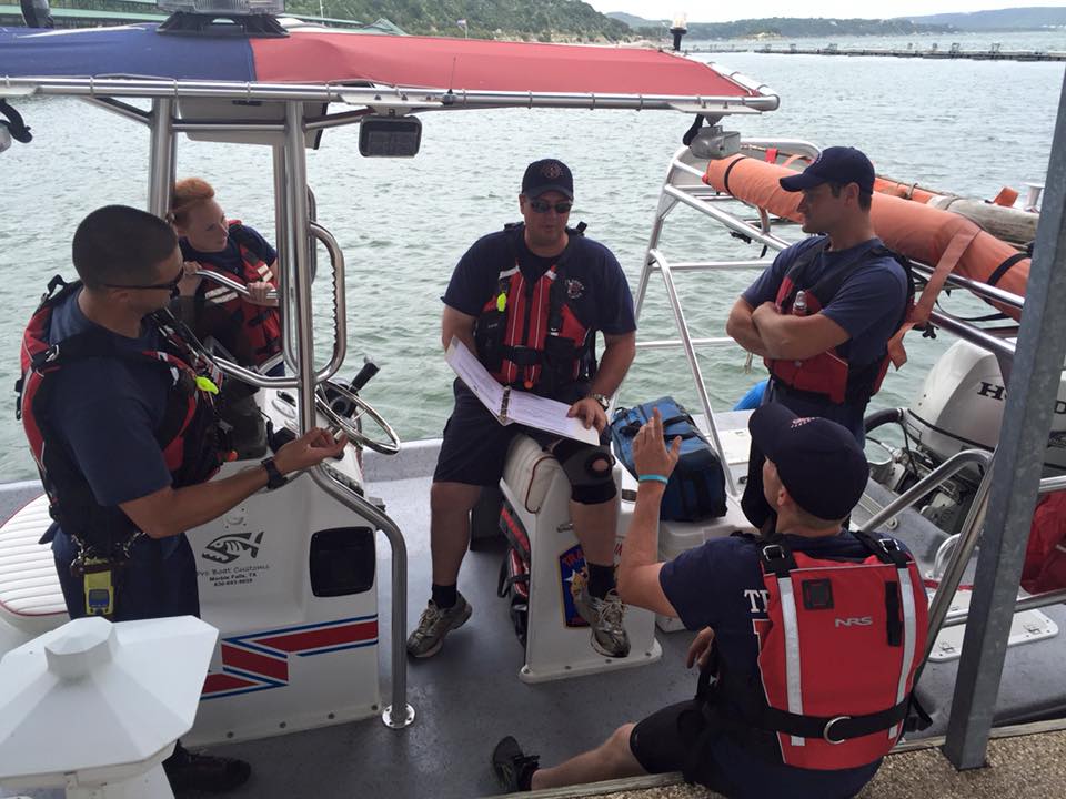 A group of men are sitting on a boat in the water