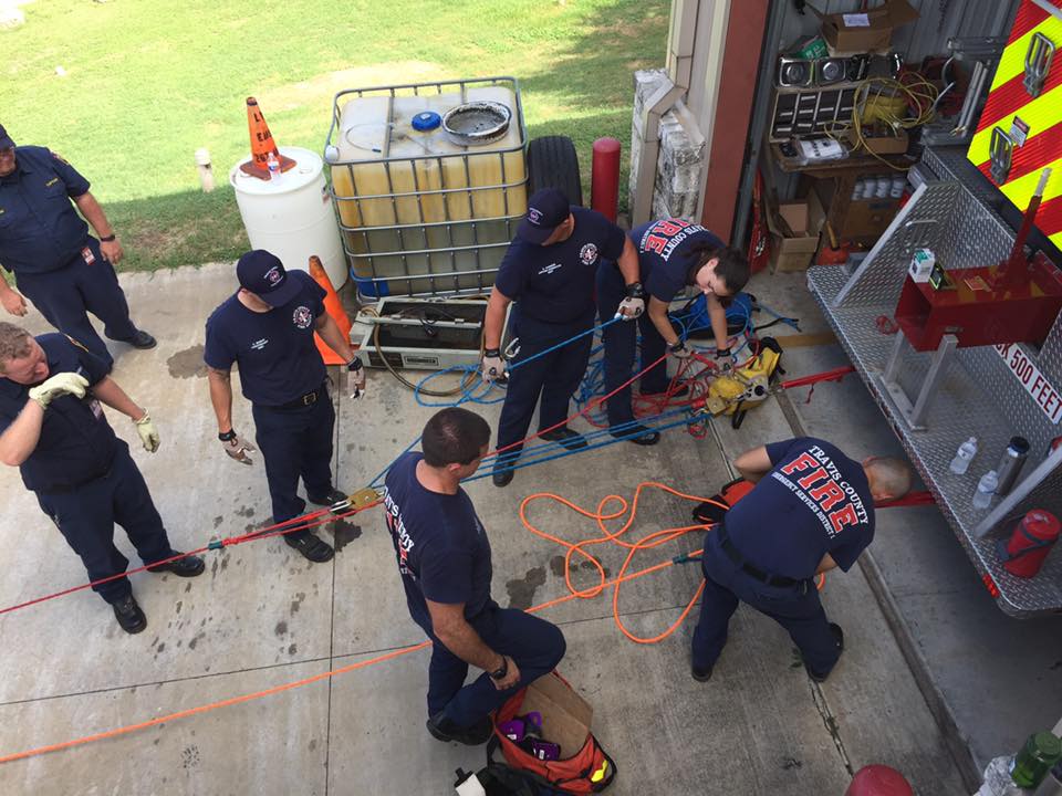 A group of firefighters are working in a garage
