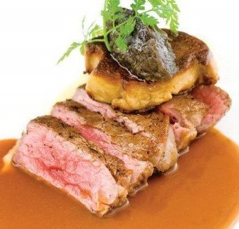 A close up of a piece of meat with sauce on a plate.