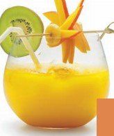 A glass of orange juice with a kiwi and mango on top.