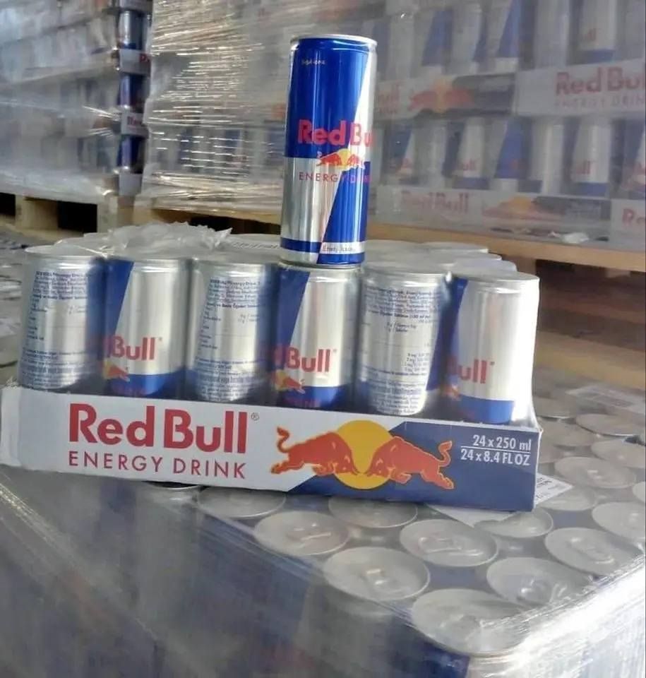 A display of Red Bull energy drink cans, in a carton with two cans standing upright, on a pallet.