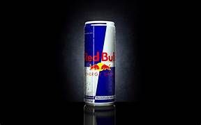 Red Bull energy drink can with blue and silver design on a black background.