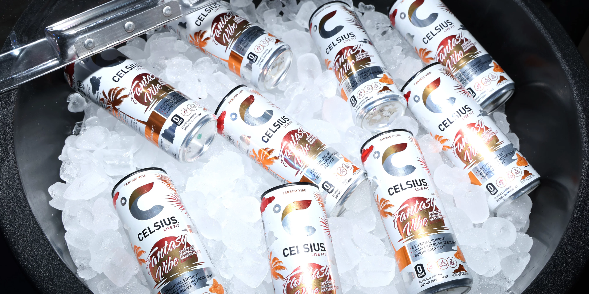 Cans of Celsius energy drink are in a metal bucket filled with ice.