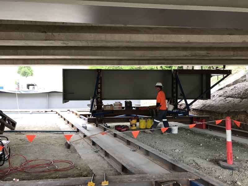 A Man In An Orange Shirt Is Working On A Construction Site | Canberra ACT | Baxter Engineering