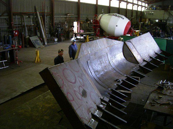 Two Men Standing Next To A Large Metal Object | Canberra ACT | Baxter Engineering