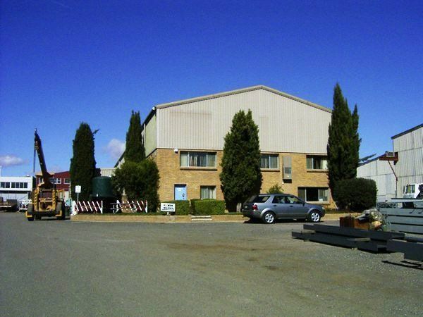 A Parking Lot With A Large Building In The Background | Canberra ACT | Baxter Engineering